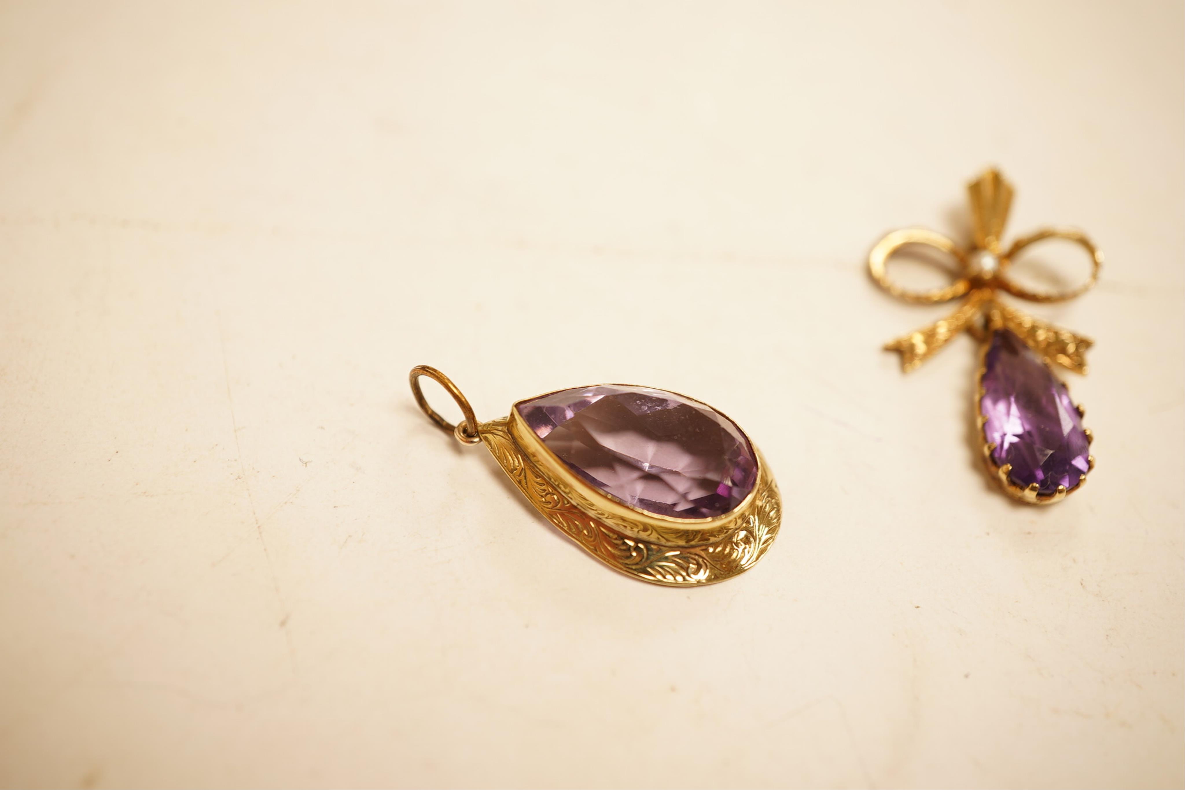 A 1970's 9ct gold, amethyst and seed pearl set drop pendant, 29mm, together with a yellow meta and amethyst set drop pendant.